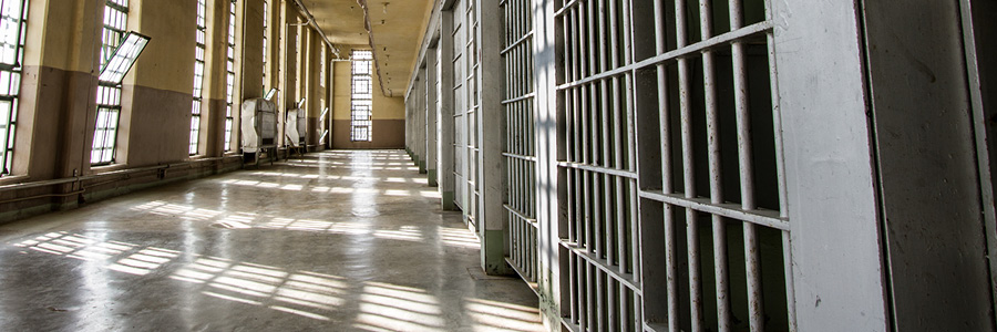 Image of hallway of prison and rows of cells